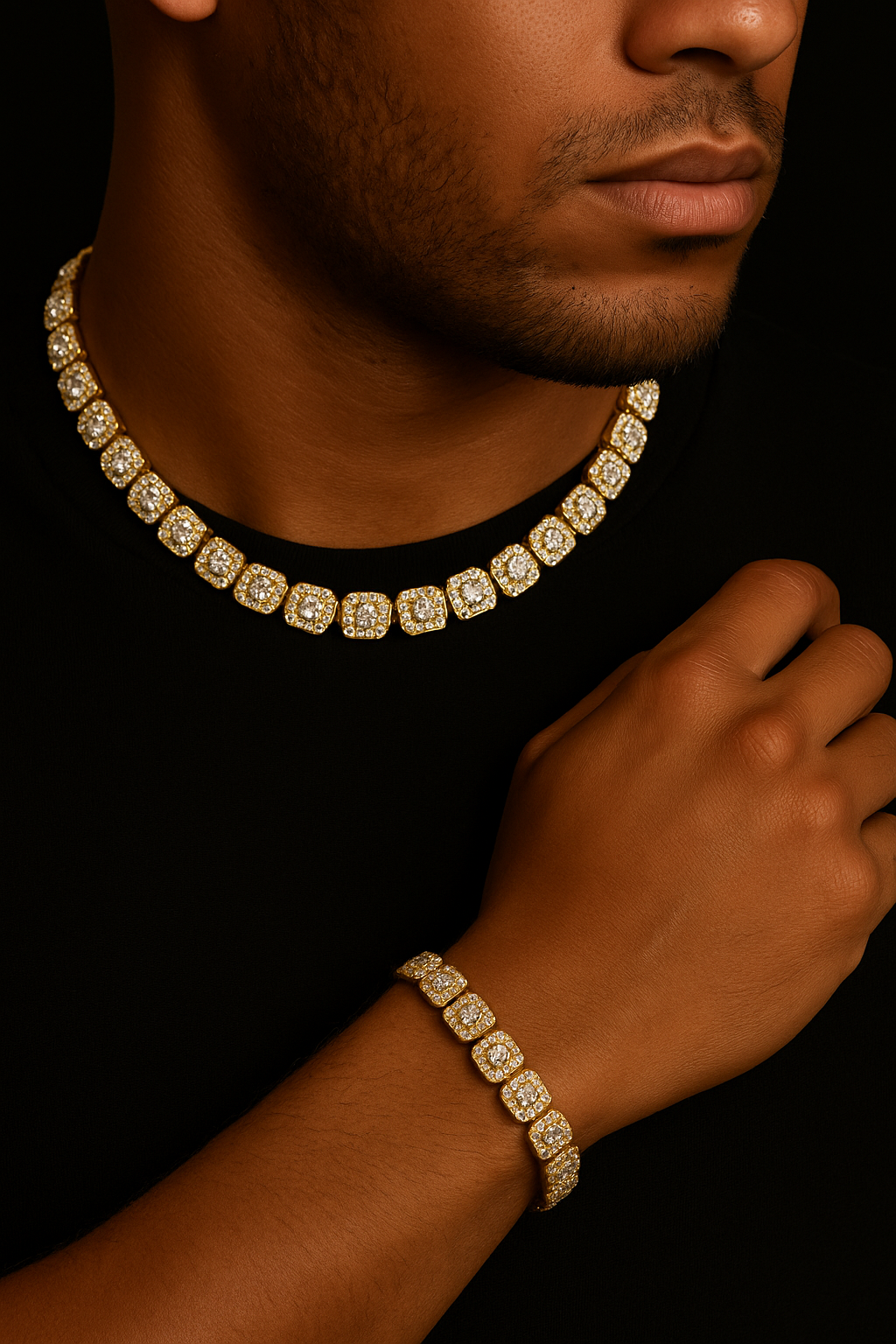 Man wearing a gold chain necklace and bracelet on a black background