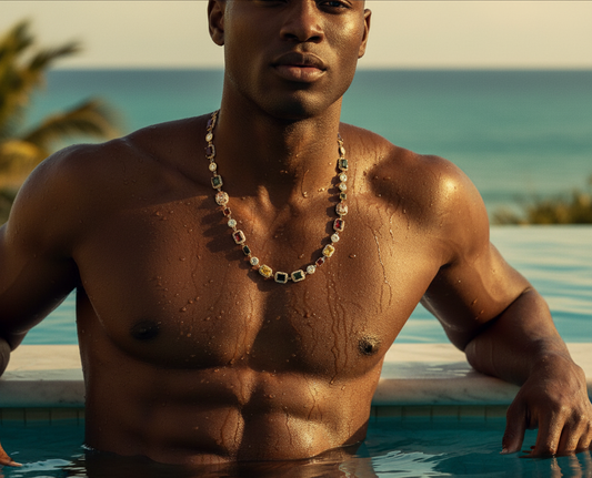 Man with a necklace standing by a pool with ocean view
