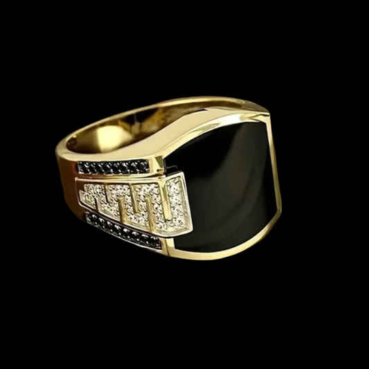 A gold-plated stainless steel ring with a large black onyx center stone and smaller white cubic zirconia accent stones.