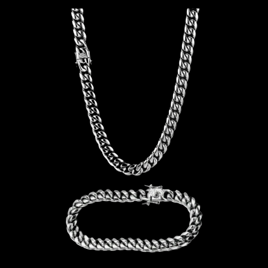 Silver chain necklace and bracelet on a black background