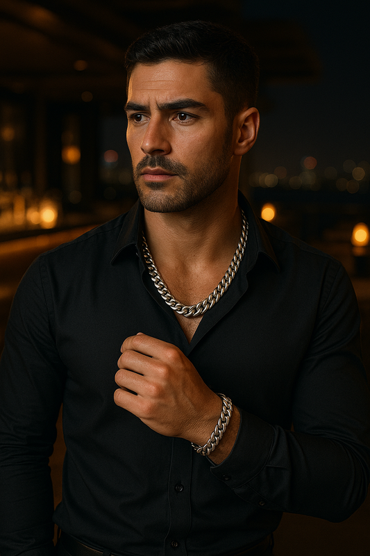 Man wearing a black shirt and chain necklace against a dark background