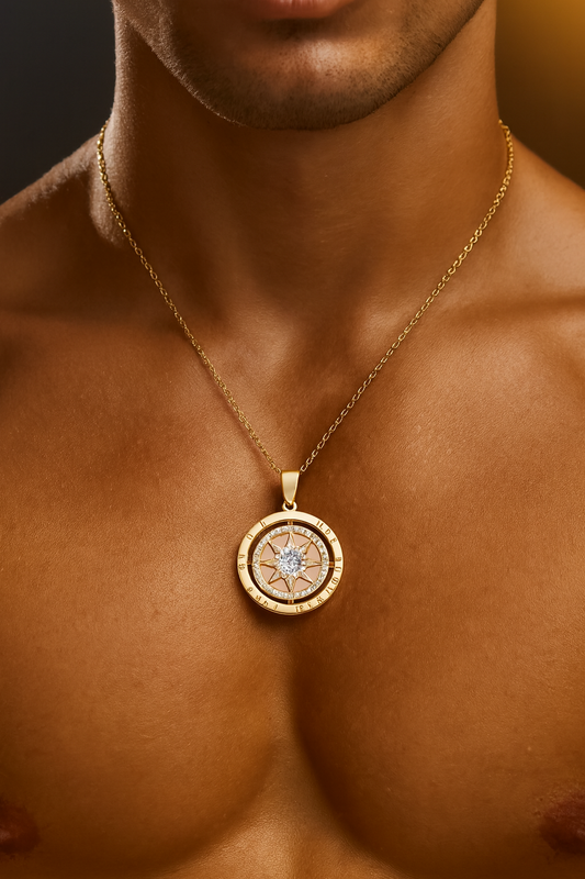 Gold necklace with a pendant on a person's chest against a dark background