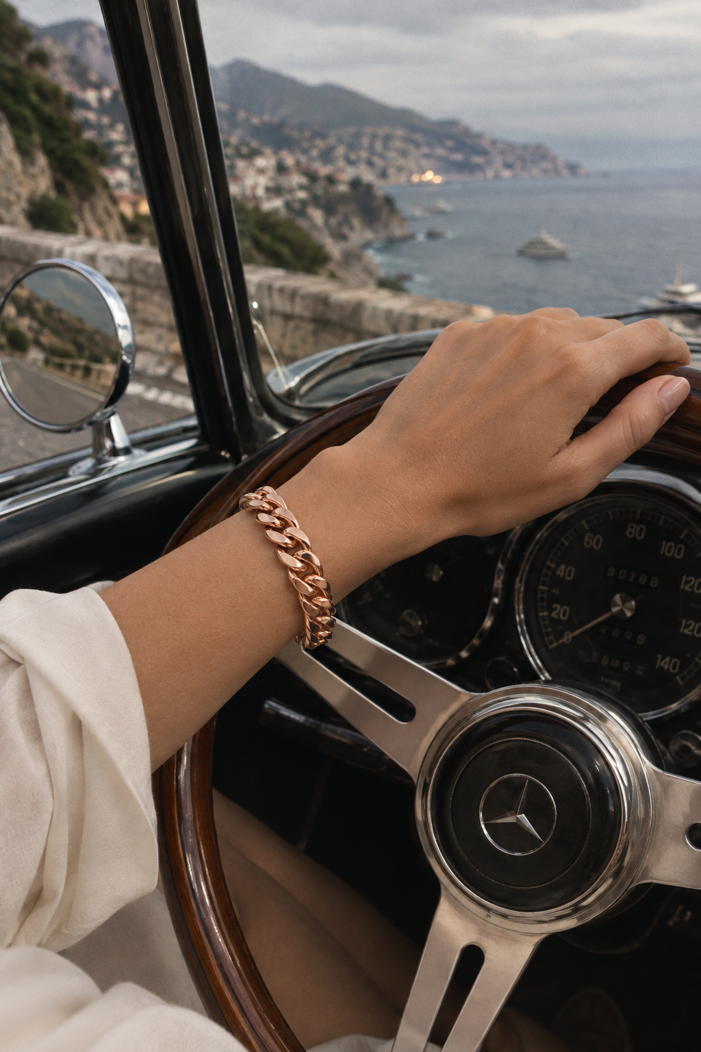 Luxor Bracelet Rose Gold worn at the wheel of a vintage convertible